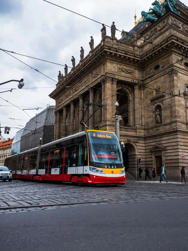 Red tram passing the National Theatre in Prague