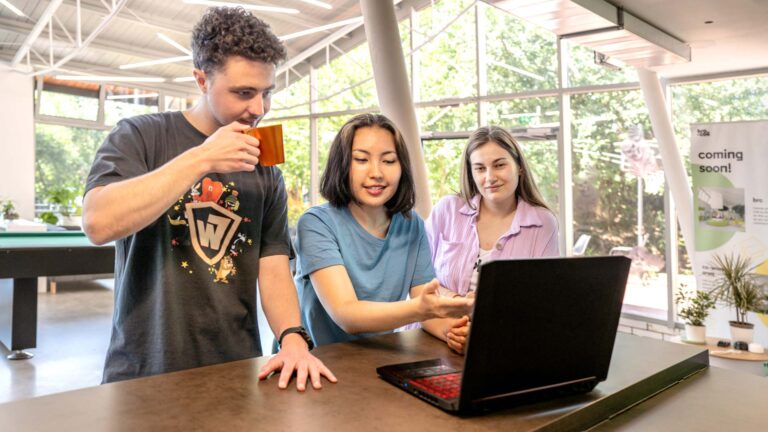 Group of friends looking at a laptop